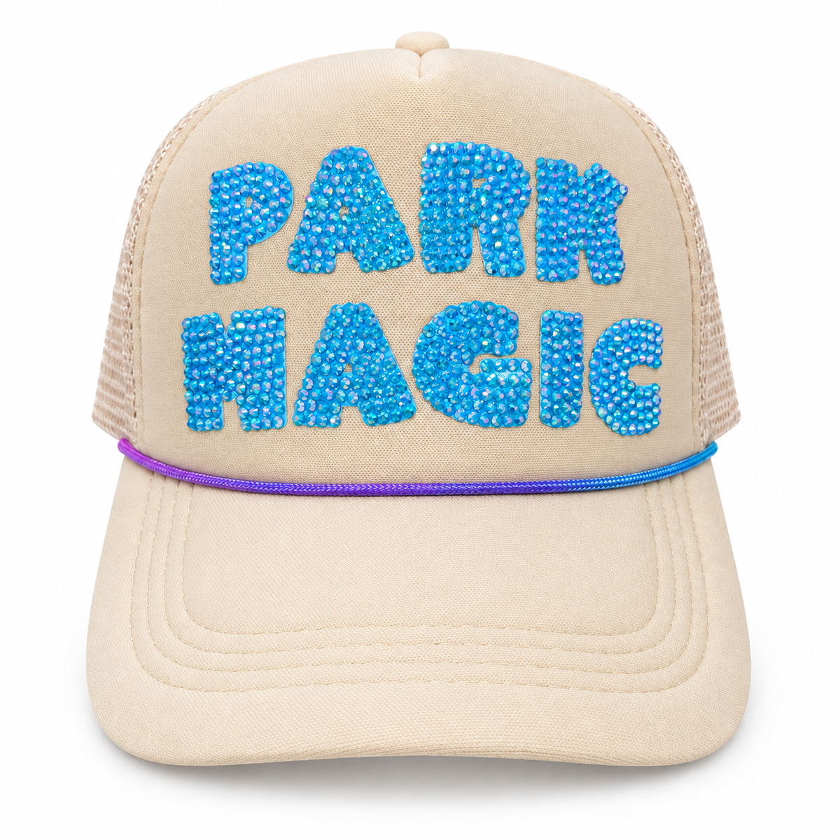 Cream trucker hat with large blue rhinestone PARK MAGIC lettering, cream mesh panels, and purple-and-blue rope trim.