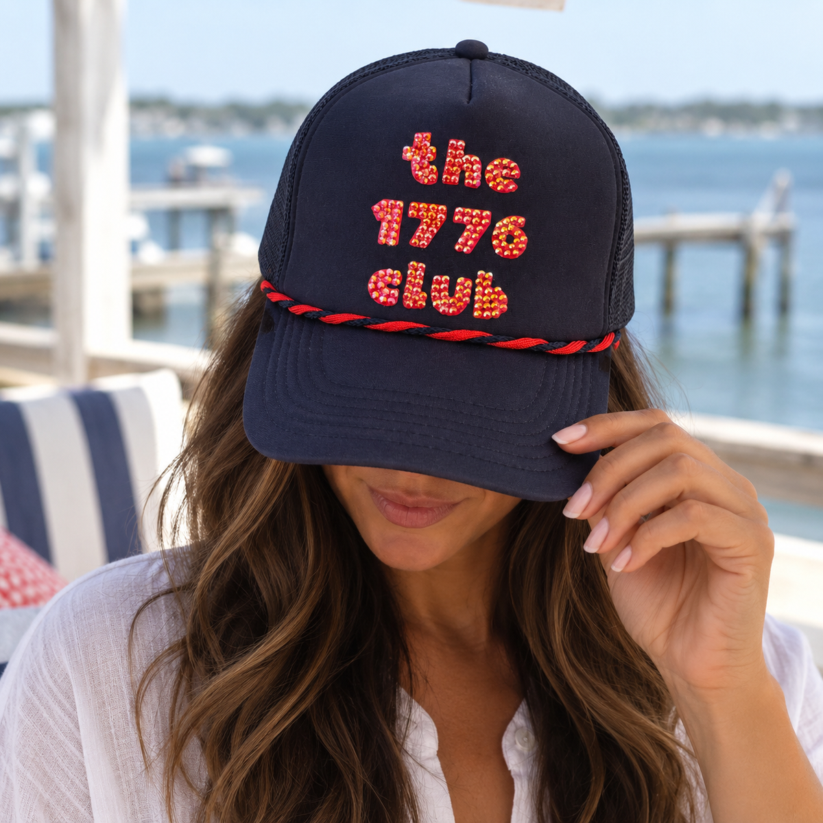 Navy trucker hat with red rhinestone the 1776 club lettering and red and navy rope trim