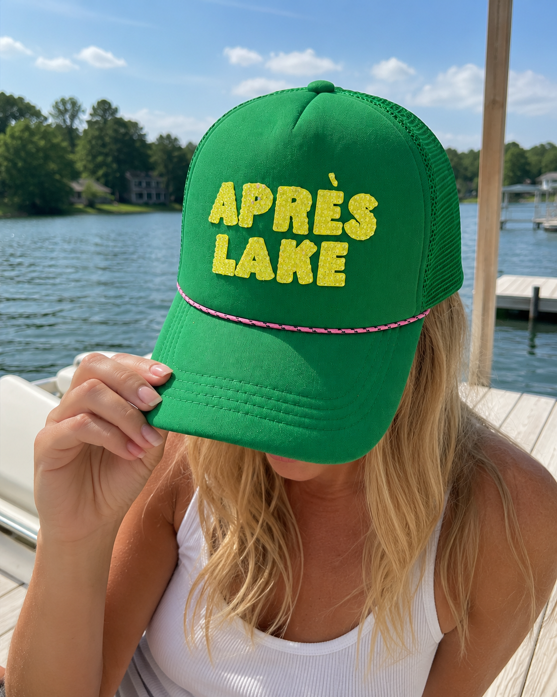 Green Après Lake bedazzled trucker hat with yellow crystal lettering and pink rope detail