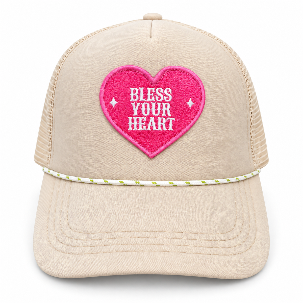 Cream trucker hat with a hot-pink heart patch reading Bless Your Heart in white and white rope trim with green accents.