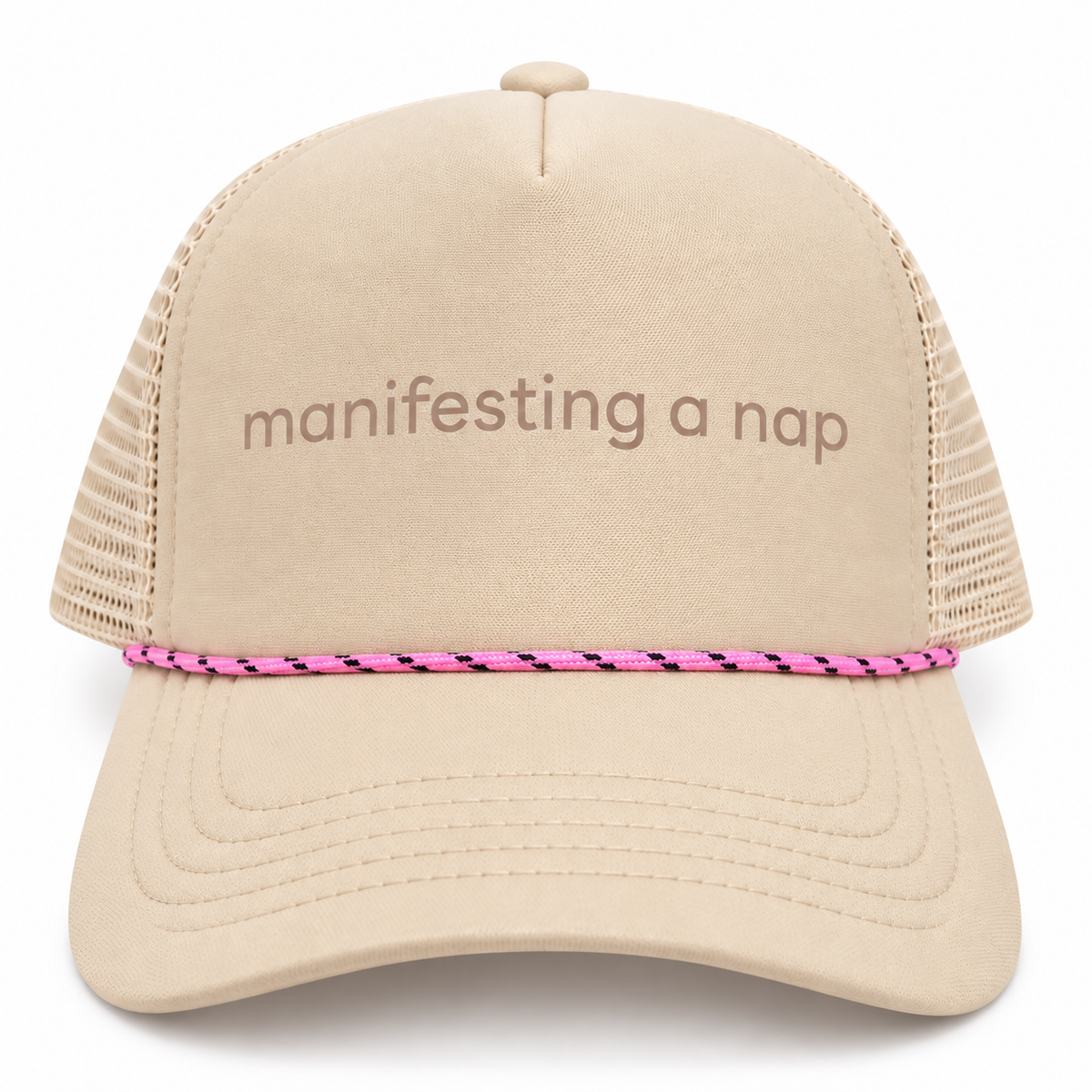 Tan trucker hat with embroidered manifesting a nap text and pink and black rope trim